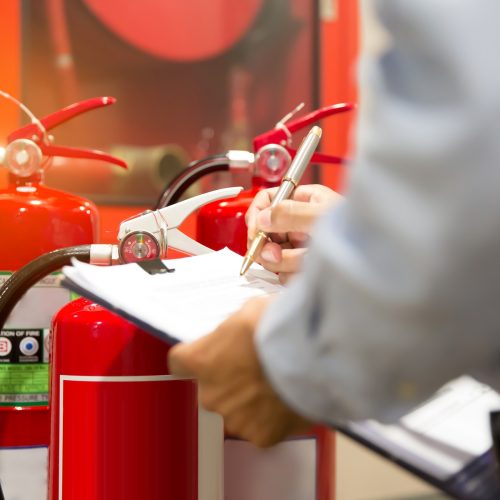 Engineers are checking fire extinguishers.